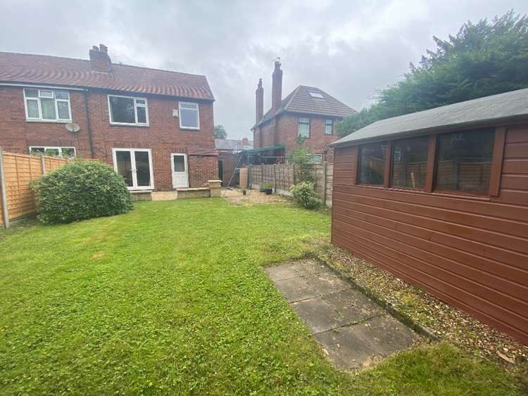 The rear view of this idyllic Macclesfield home, complete with spacious garden.