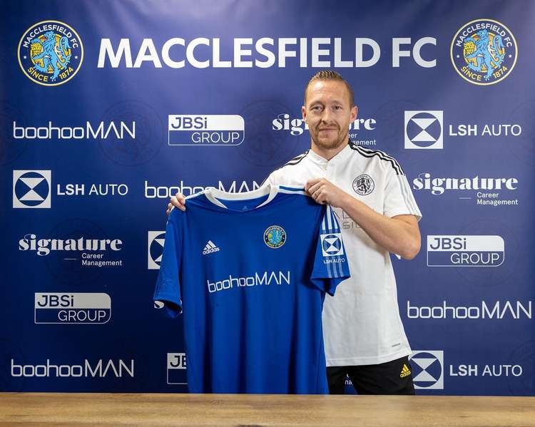 It is all smiles for Scott as he signs for the Silkmen.