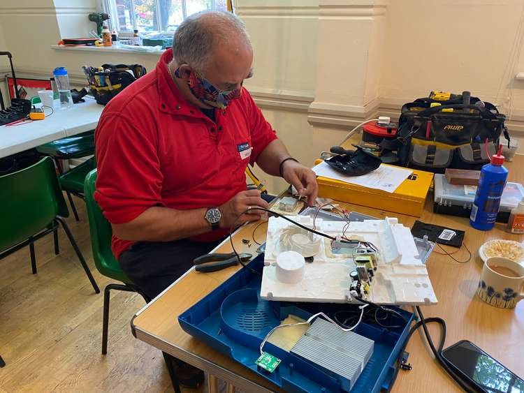 Macclesfield Repair Café Volunteer Neil repairs an computer circuit. A crowdfunder will help cover his material costs.