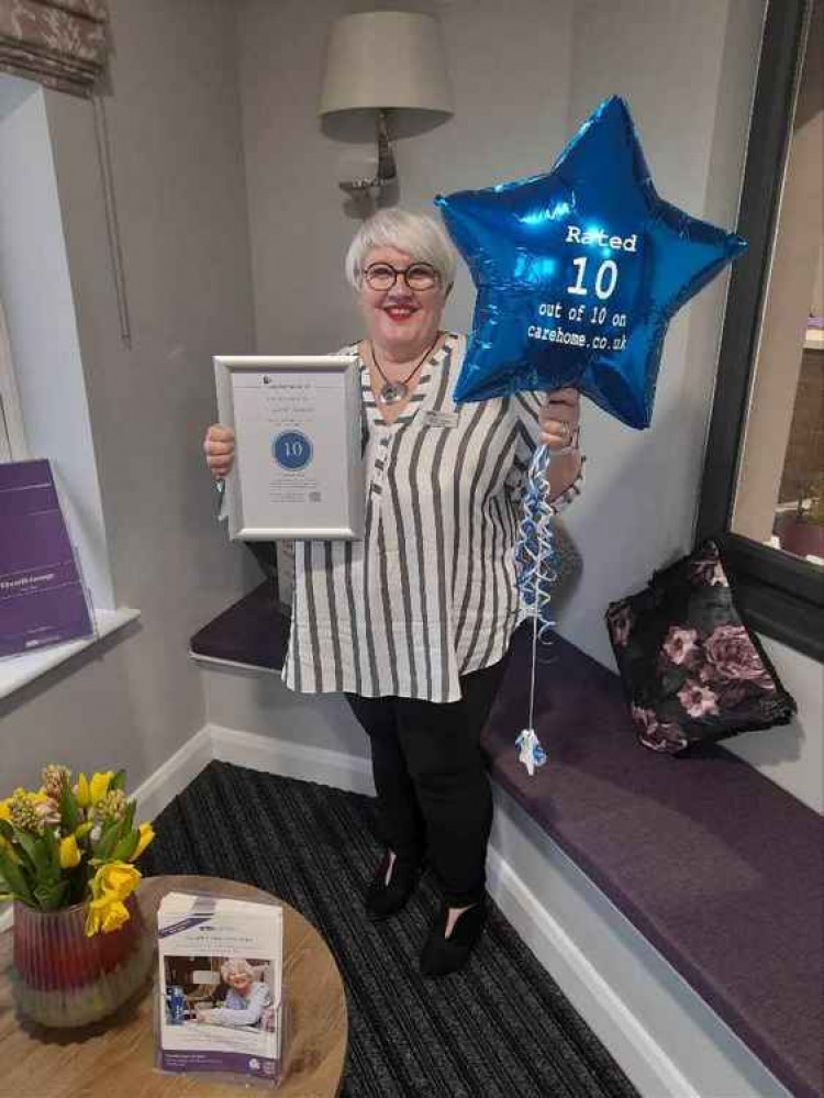 Home Manager, Donna Cowell, holding her certificate from Carehome.co.uk