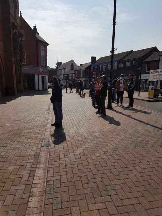 Customers queued outside in the sun.