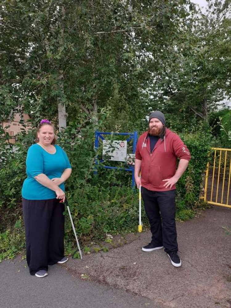 Cllr Crane and Sam Porter at the playground entrance with their litter pickers