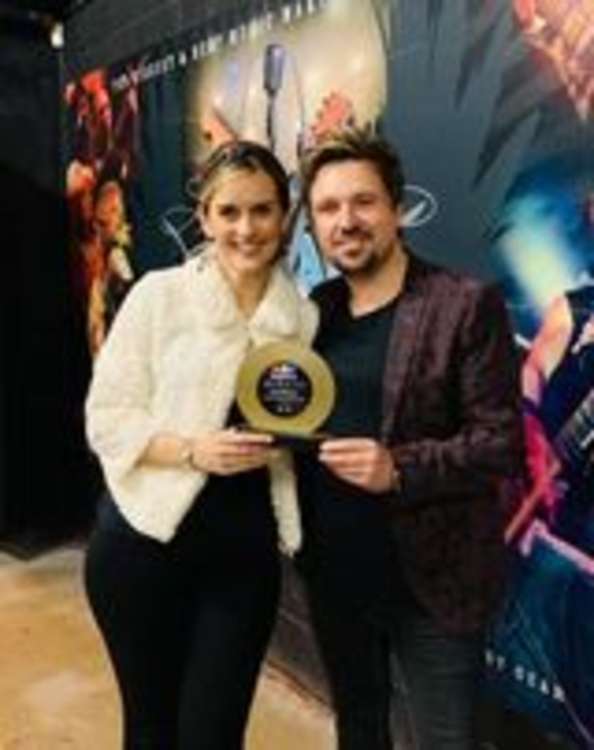 Rob Wheeler collecting his Songwriter of the Year award with fiancee Rebecca Powell