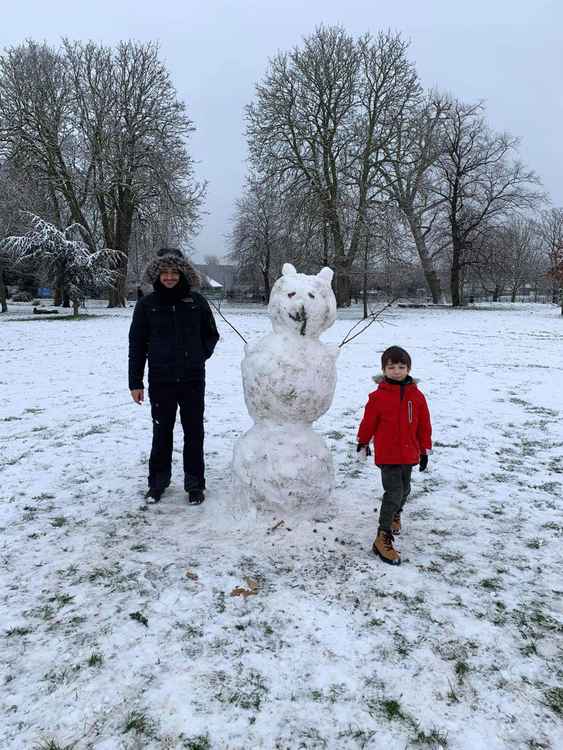 Father and son, Philipos and Harry with their snowman in Acton Park. Image Credit: Gaelle Valcke