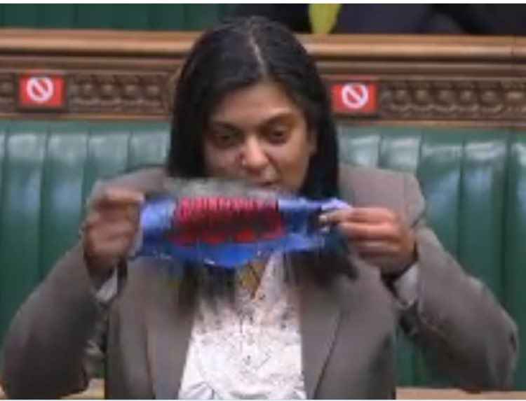 Ealing Central and Acton MP, Rupa Huq turning the face mask inside out. Image Credit: Rupa Huq