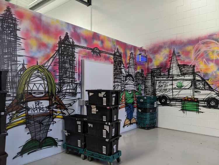 Art by Nathan Bowen covers the walls in the City Harvest warehouse. Image Credit: Anahita Hossein-Pour