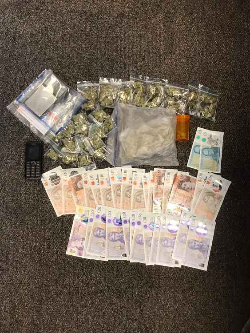 The cannabis and cash seized at the property in Northolt. Image Credit: Ealing Police