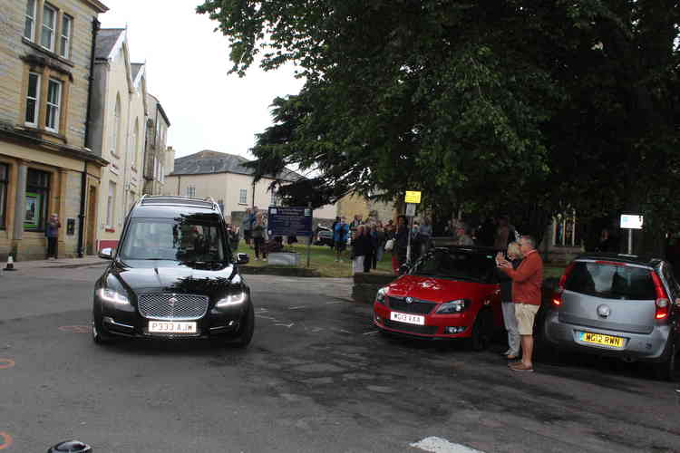 Douglas Hull's memory is honour by the gathering clapping as the hearse leaves Trinity Square