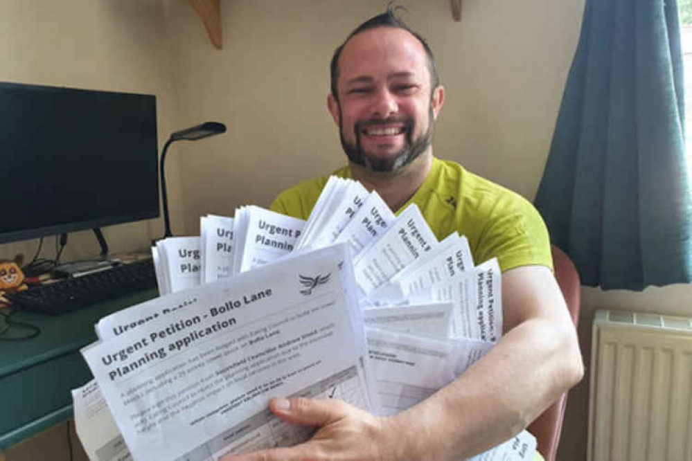 Leader of Ealing Lib Dems, Gary Malcolm, with several petition forms against large developments