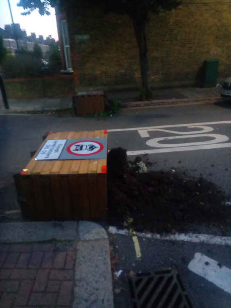 Both LTN planters on the Popes Lane/Olive Road junction have been pushed over. Image Credit: Marc Yonder