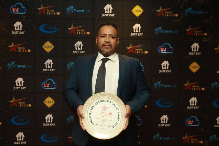 Haweli owner Manik Miah with the award. (Image: Curry Life)