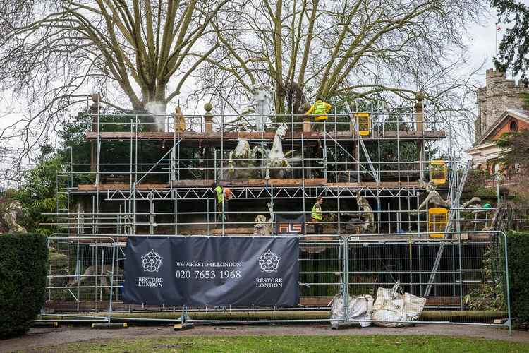 The statues encased in scaffolding