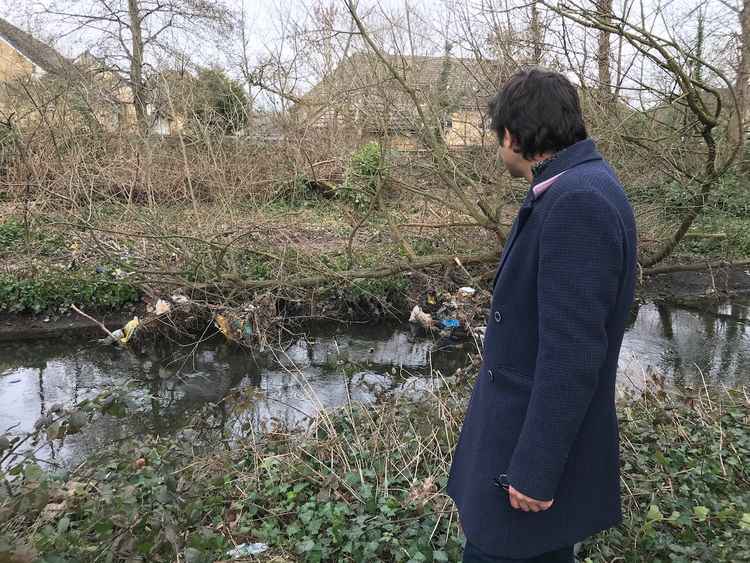 Councillor Salman Shaheen surveys the polluted banks