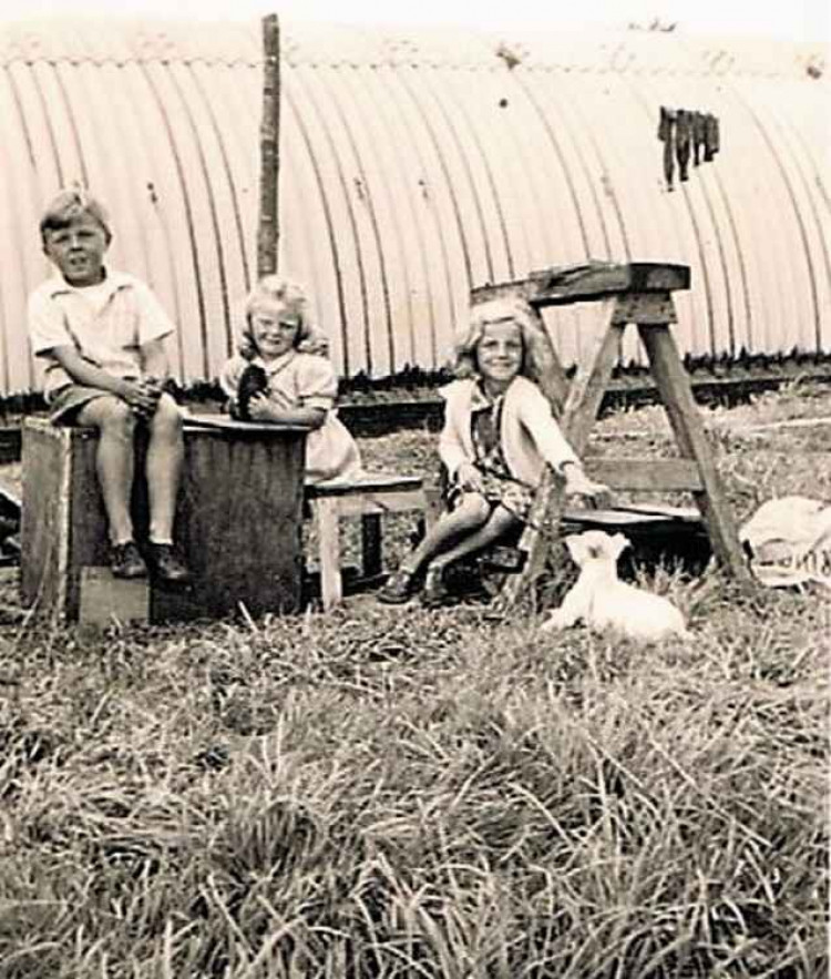 Me, Molly, cousin Rosemary and Nippy playing beside the Nissen hut