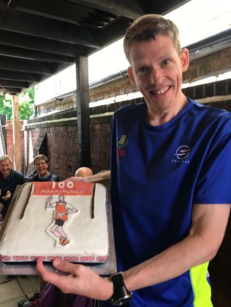 Michael Wiggins with a celebratory cake made by his mum