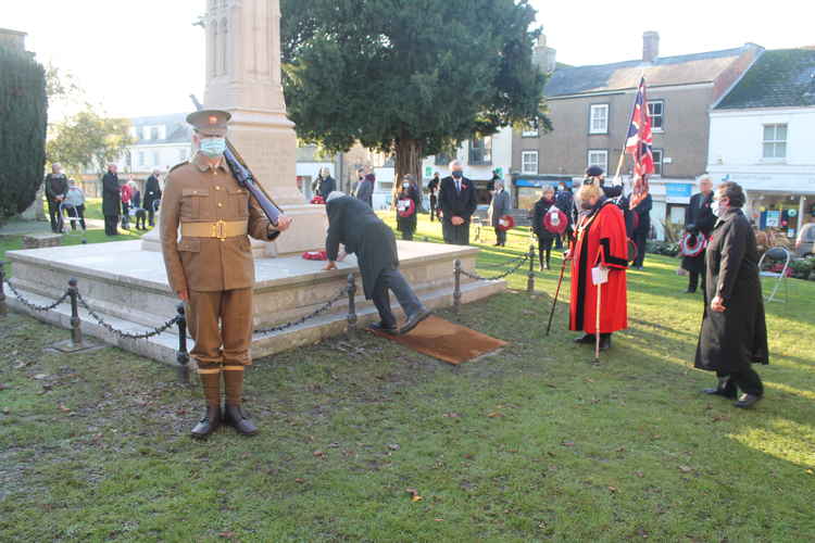 The first wreath is laid at the war memorial by the Mayor of Axminster, Cllr Annie Young