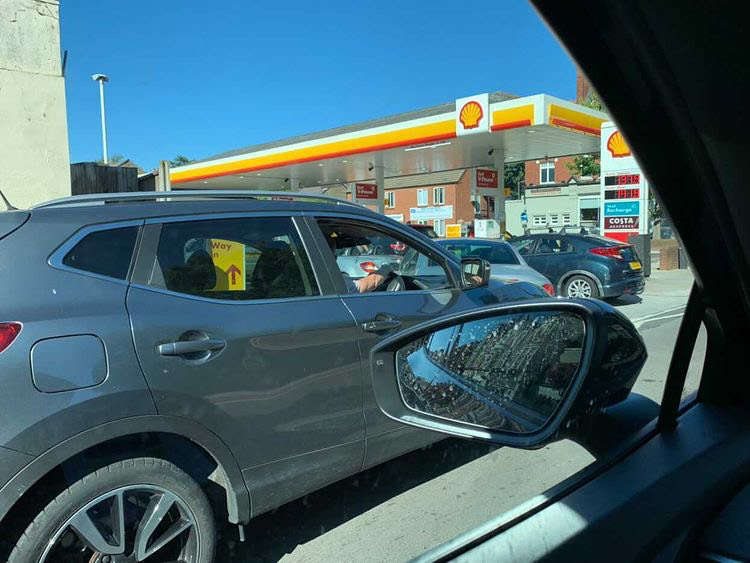Shoppers wait patiently for their turn at the pump. Credit: Joe Poulter.
