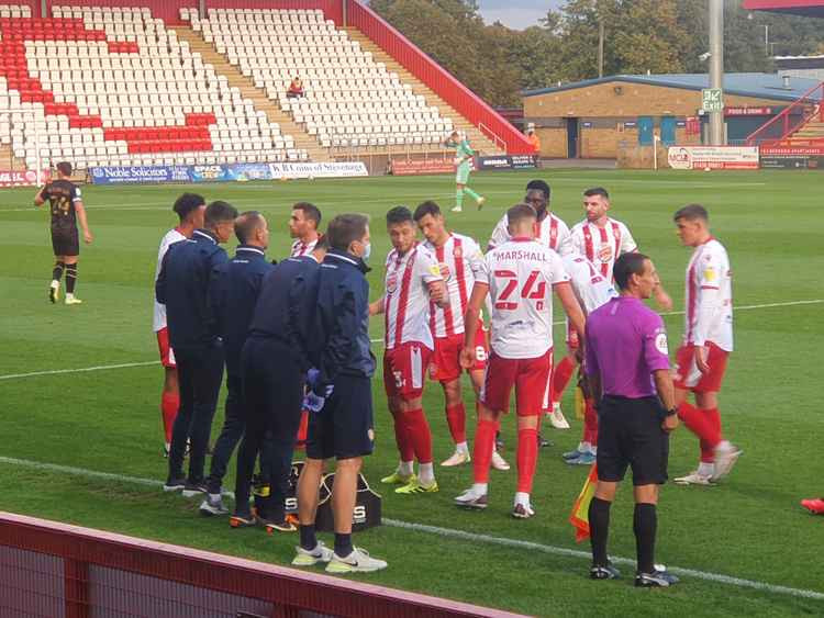 Before the deluge, Boro regroup during a first half drinks break during their 3-2 defeat by MK. CREDIT: @laythy29