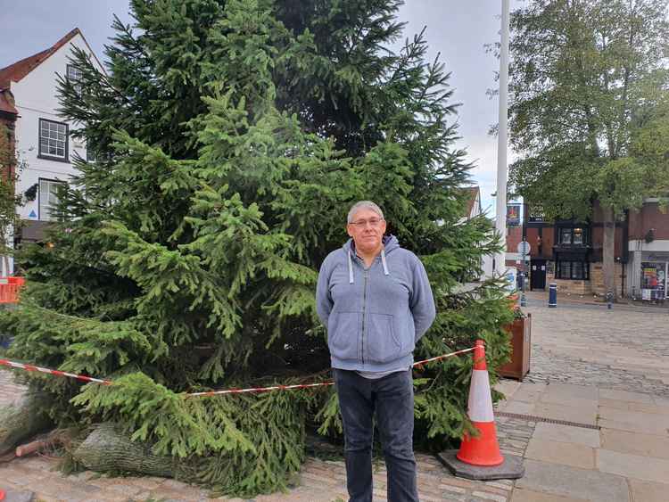 The moving story behind Hitchin's Christmas tree lights. PICTURE: Ian Albert in front of Hitchin's Christmas tree. CREDIT: Hitchin Nub News