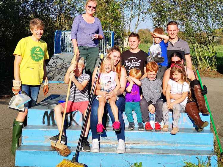 Youngsters pictured cleaning up the old skatepark site in Axminster