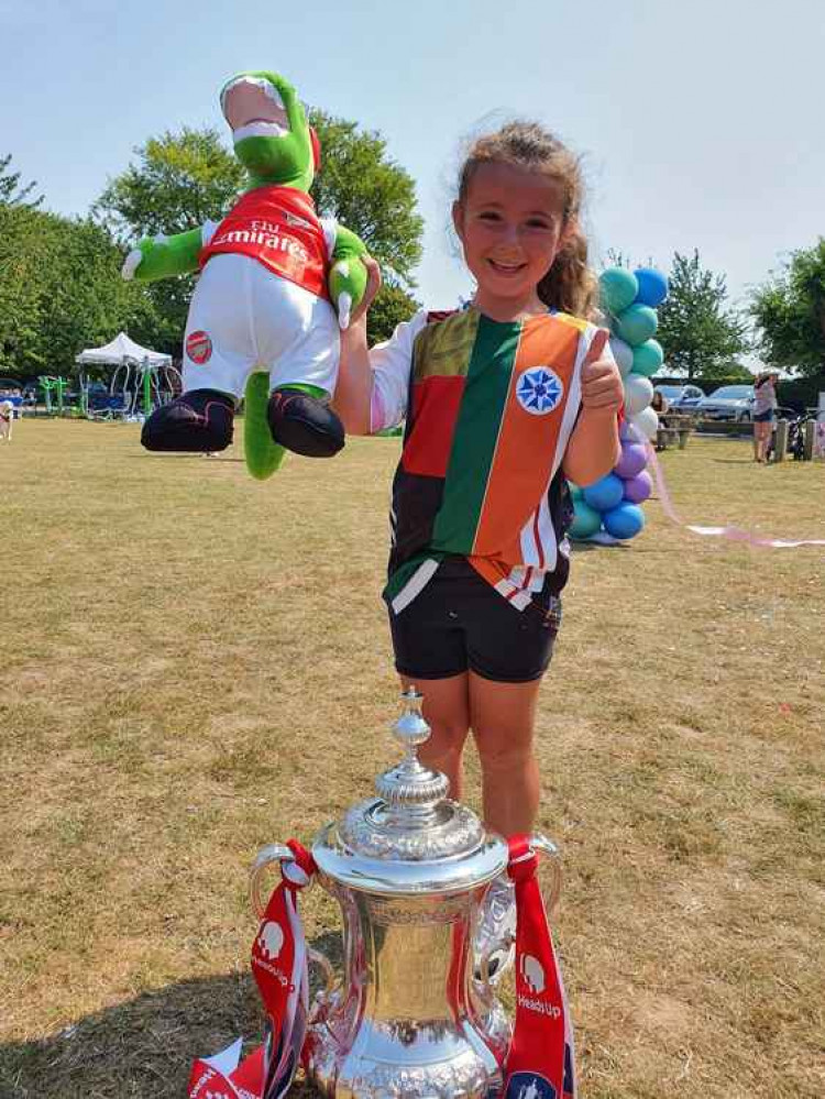 Inspirational Betty Leigh-Allinson is once again set to raise money for charity. PICTURE: Brilliant Betty last summer hat Codicote FC with the FA Cup. CREDIT: @HitchinNubNews