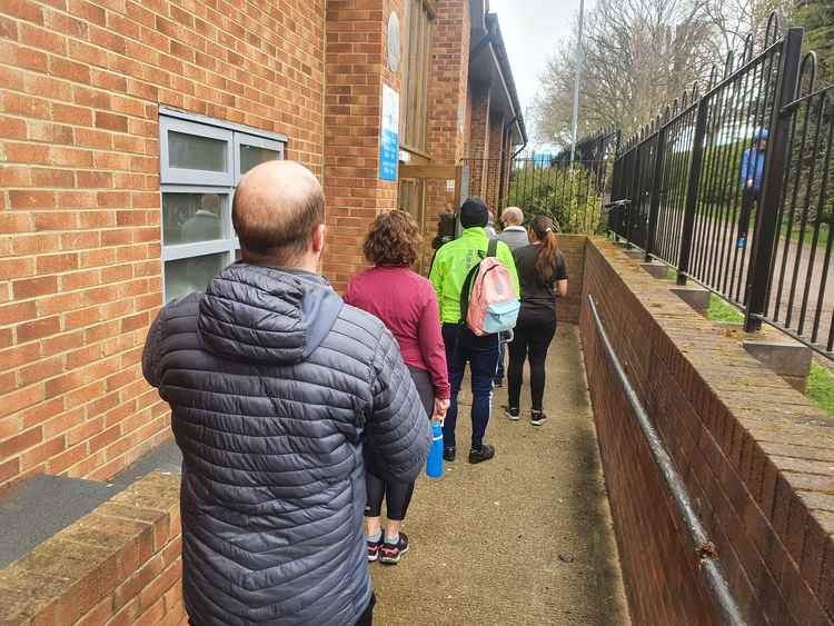 Members queue patiently as they wait to return to the gym