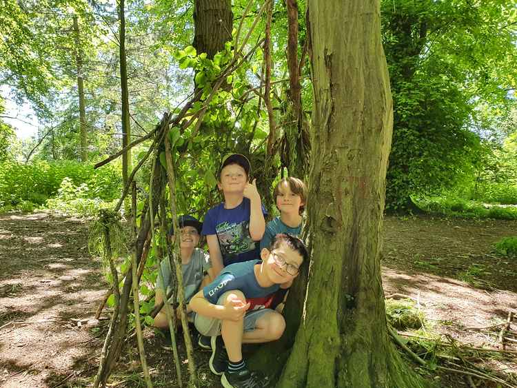 The children used social skills and creativity to create dens in the woods.