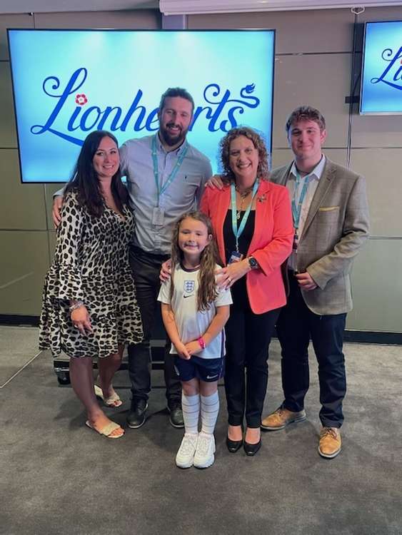 Betty Leigh with mum Faye and dad Lee alongside Sir Captain Tom's daughter and grandson. CREDIT: Sir Captain Tom Moore Foundation