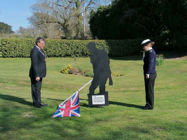 Royal British Legion chairman Mervyn Symes and Axminster Branch member Luena Thomas, a Petty Officer Submariner, marking the two minute-silence in memory of the late Duke of Edinburgh