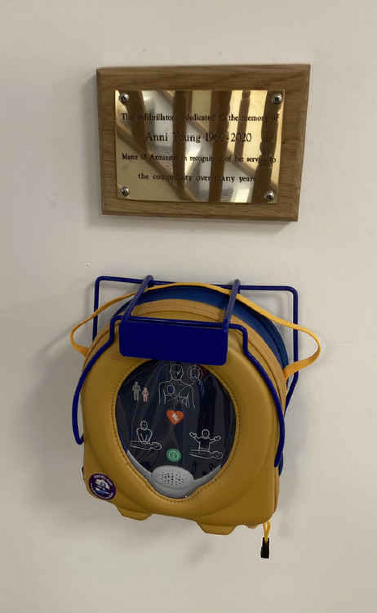 The defibrillator and plaque dedicated to Anni Young's memory at Trinity House (photo by Paul Hayward)