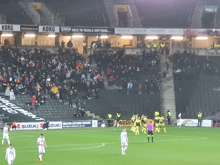 Elliot List and the Stevenage team celebrate with the travelling fans after Boro went 2-1 ahead at Stadium MK. CREDIT: @laythy29