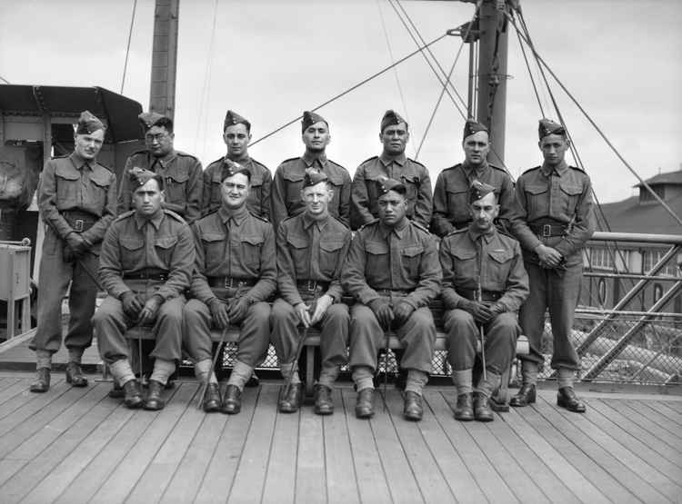 Officers from the 28th Maori Battalion taken in Sydney Harbour in November 1940, showing some of the officers holding similarly-carved swagger sticks