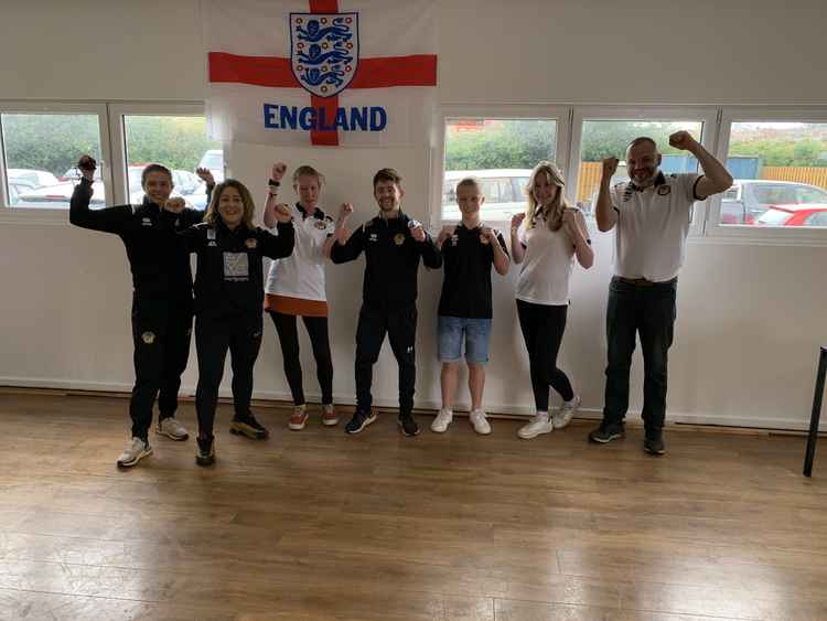 Axminster Town manager Dan Prettejohn and helpers at the club fun day giving a pre-match cheer for England