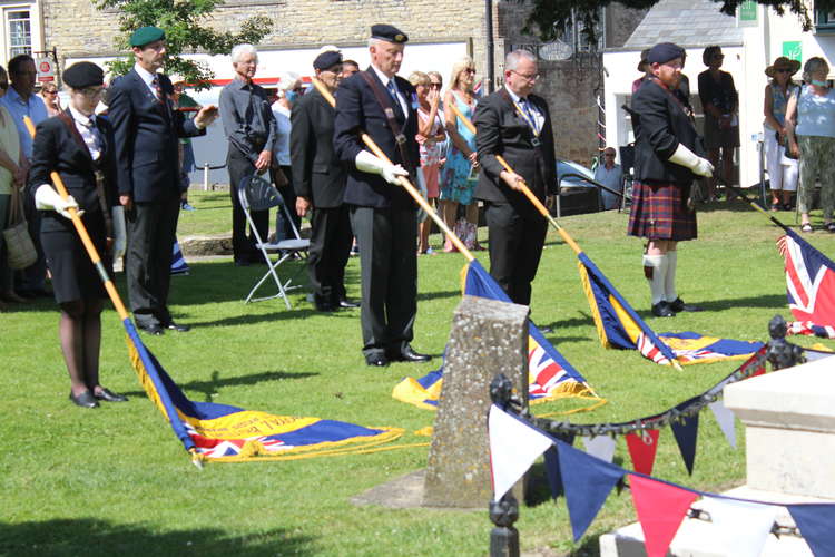 The standards are lowered at the war memorial for the two minute silence