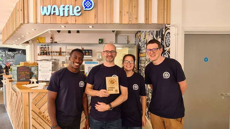 The team at the Community Waffle House with their Plastic Free Champions award