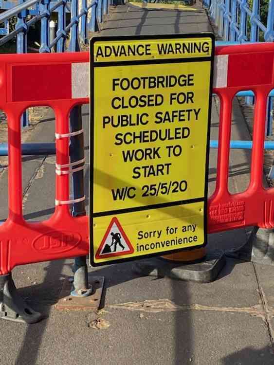 Warning sign and barrier stopping entry to bridge