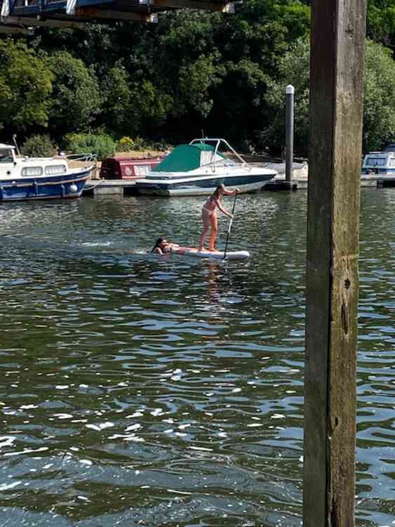 Paddle boarders,swimmers and sunbathers enjoy the Teddington scorcher