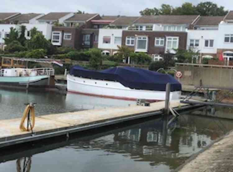 The Thamesa, now owned by John Tough, is under winter wraps at her current Chiswick mooring