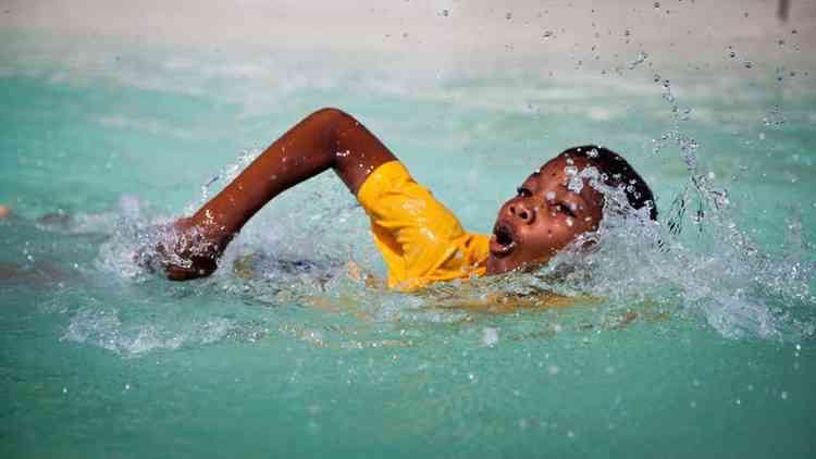 A child learning to swim in Zanzibar by Mike Lavis