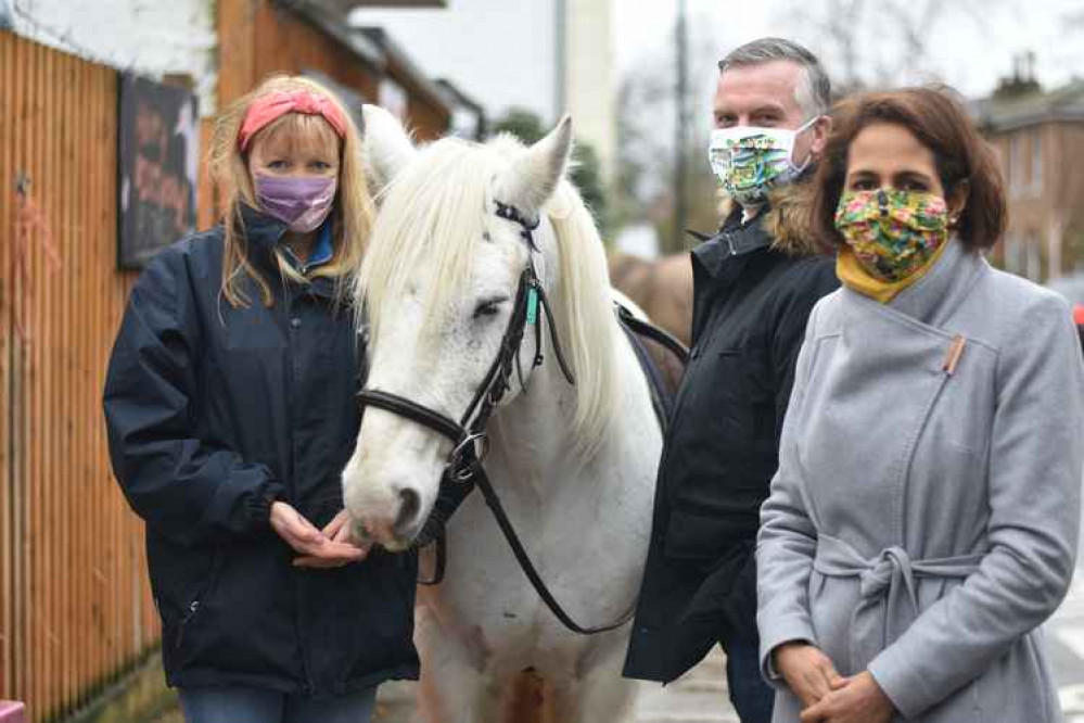 Exclusive Photo shows (left to right) Stables proprietor Natalie O'Rourke, Eddy, who has visited homes during the pandemic, council leader Gareth Roberts and Twickenham MP Munira Wilson at Park Lane Stables on Friday