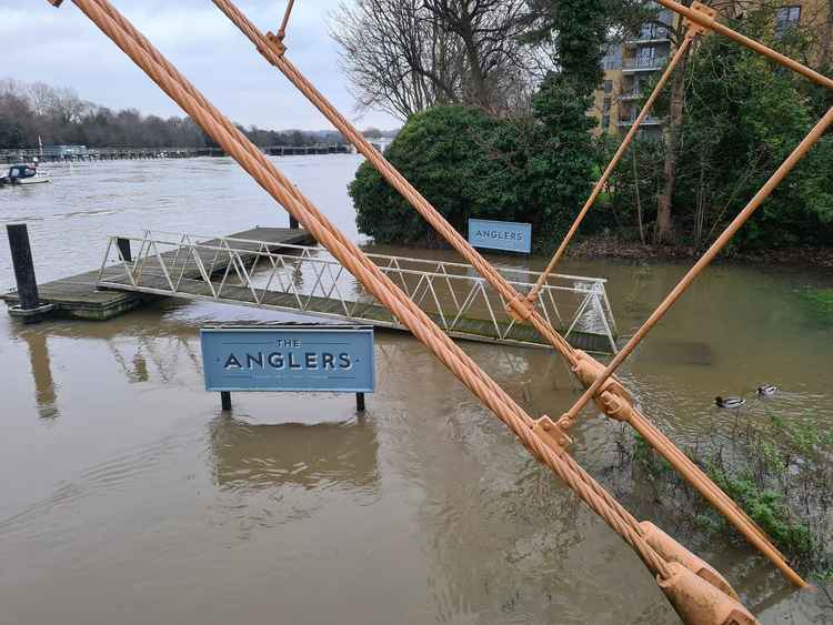 The Anglers' sign stands in the water