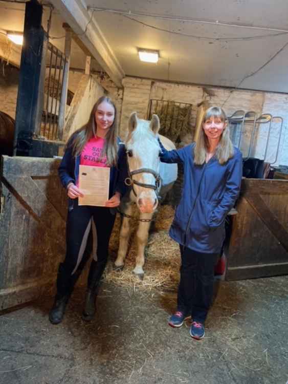 Stables volunteer Bess (left) and her mum Caitlin with the letter from Buckingham Palace.