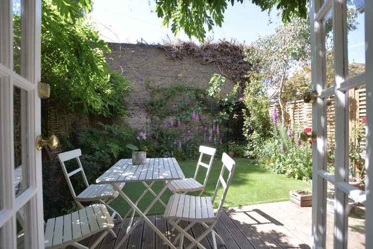 Outside there is a back garden planted with beautiful blooms