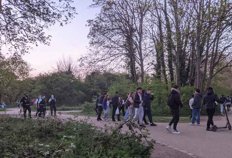 Police break up a gathering of youths in the woods by Teddington Lock