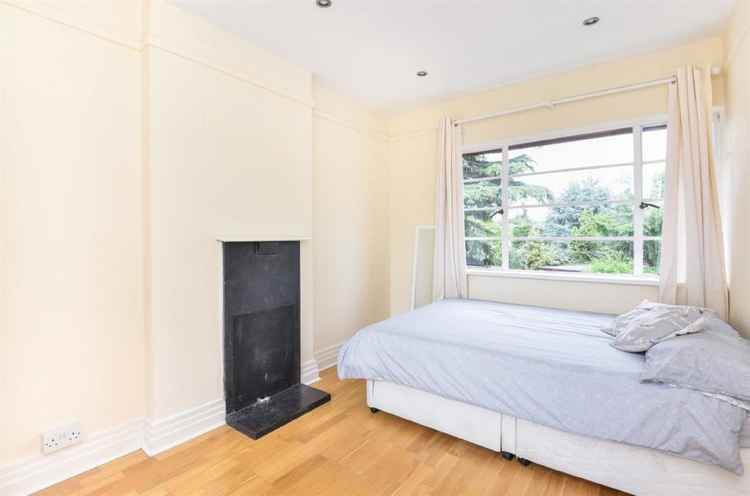 The master bedroom has room for a double bed and also features an original fireplace