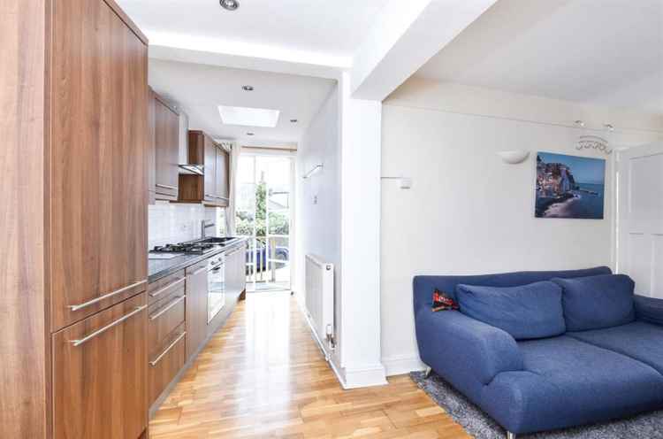 Another view of the kitchen showing the living area has an open-plan design