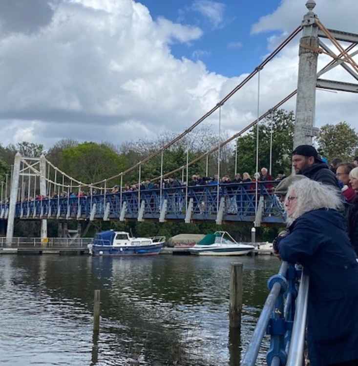 Onlookers line the bridge