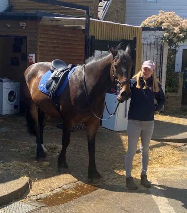 Distraught Natalie leads Des the horse away from the stables