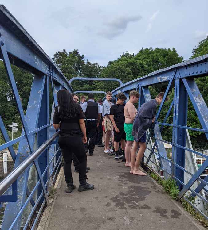 Police move groups away from the Ham river wall before the gates of Teddington Lock open