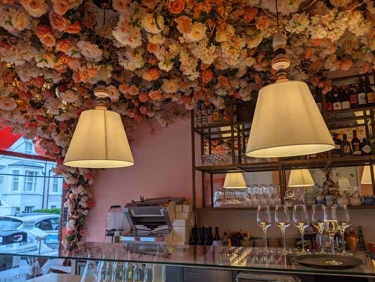 Gorgeous flowers line the ceiling above the bar. The restaurant's decor is inspired by Mayfair Club Annabel's